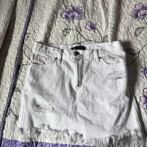 White distressed denim shorts with zip up front